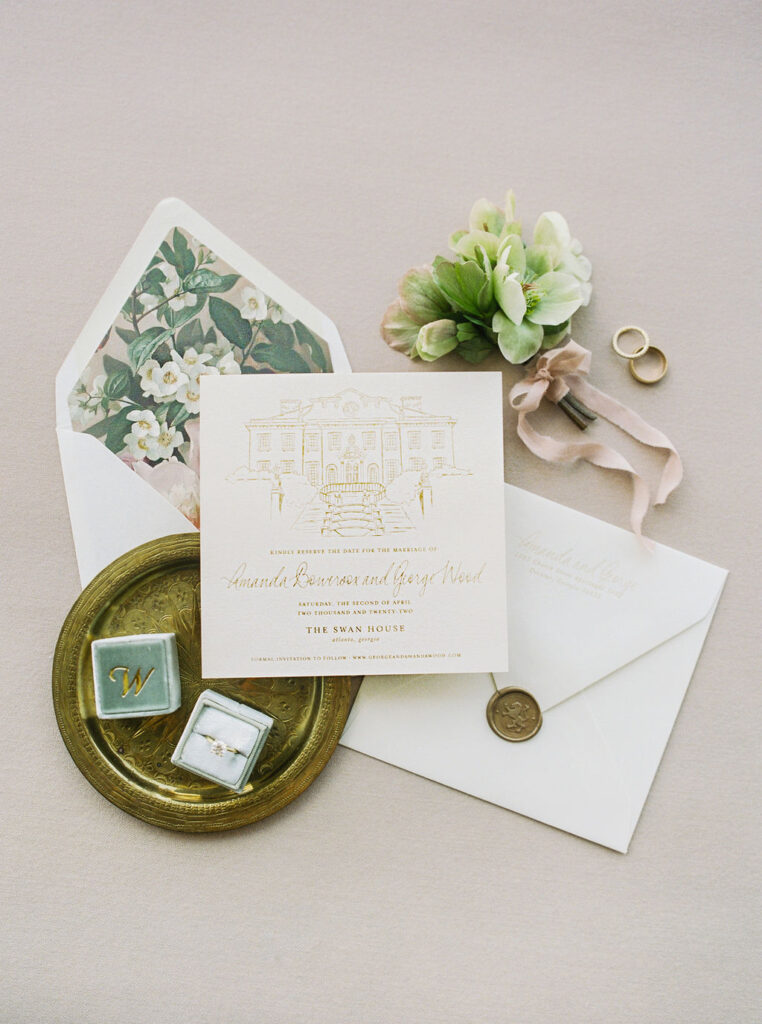 wedding invitation with dogwood flowers and gold lettering