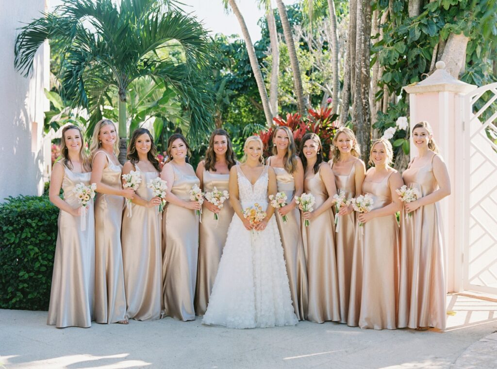 bridesmaids in champagne satin gowns with petite bouquets